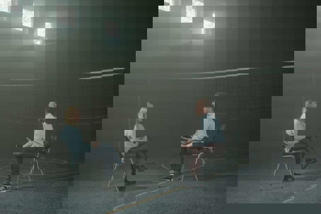 people sitting next to a volleyball net