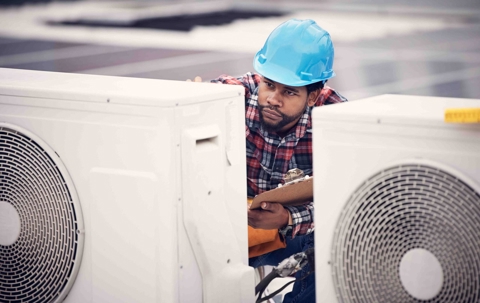 technician working on an ac unit