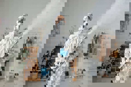 man spraying a house